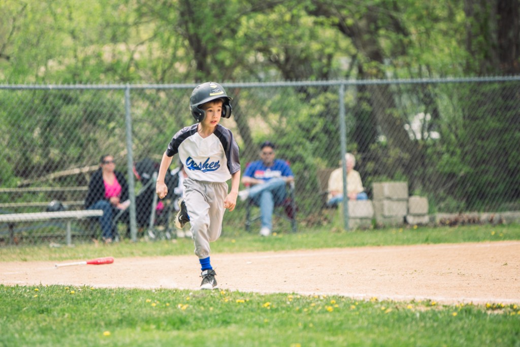 little boy running during baseball game