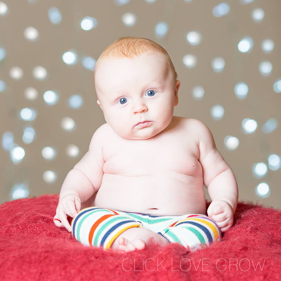 baby with christmas lights bokeh background