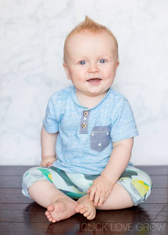 baby boy smiling with vinyl photo backdrop