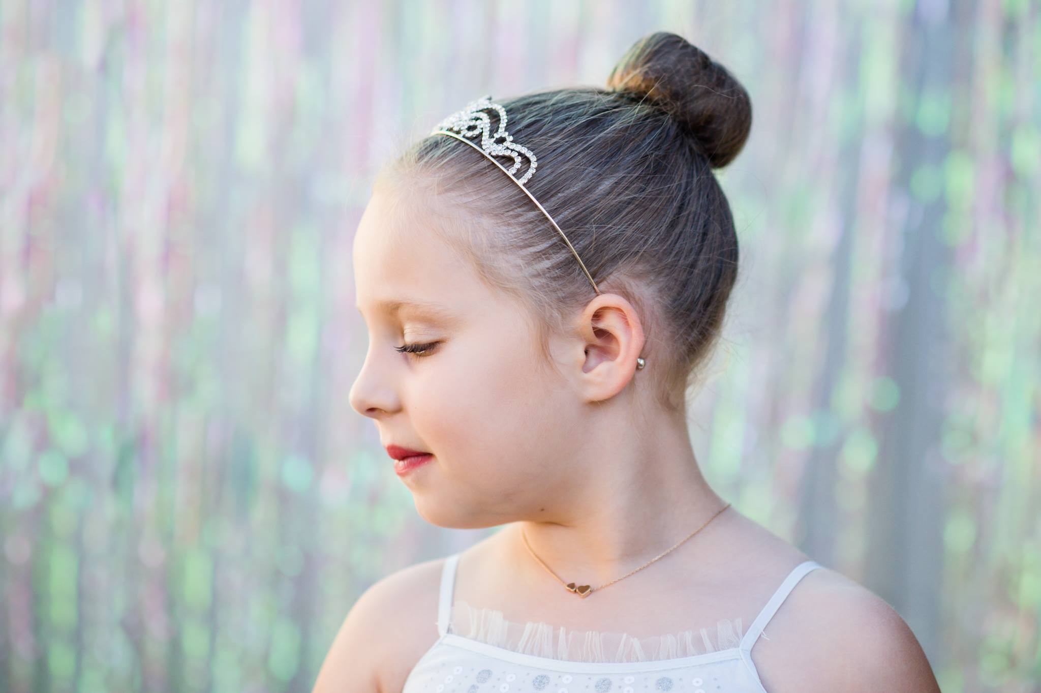 girl wearing a tiara with curtain photo backdrop