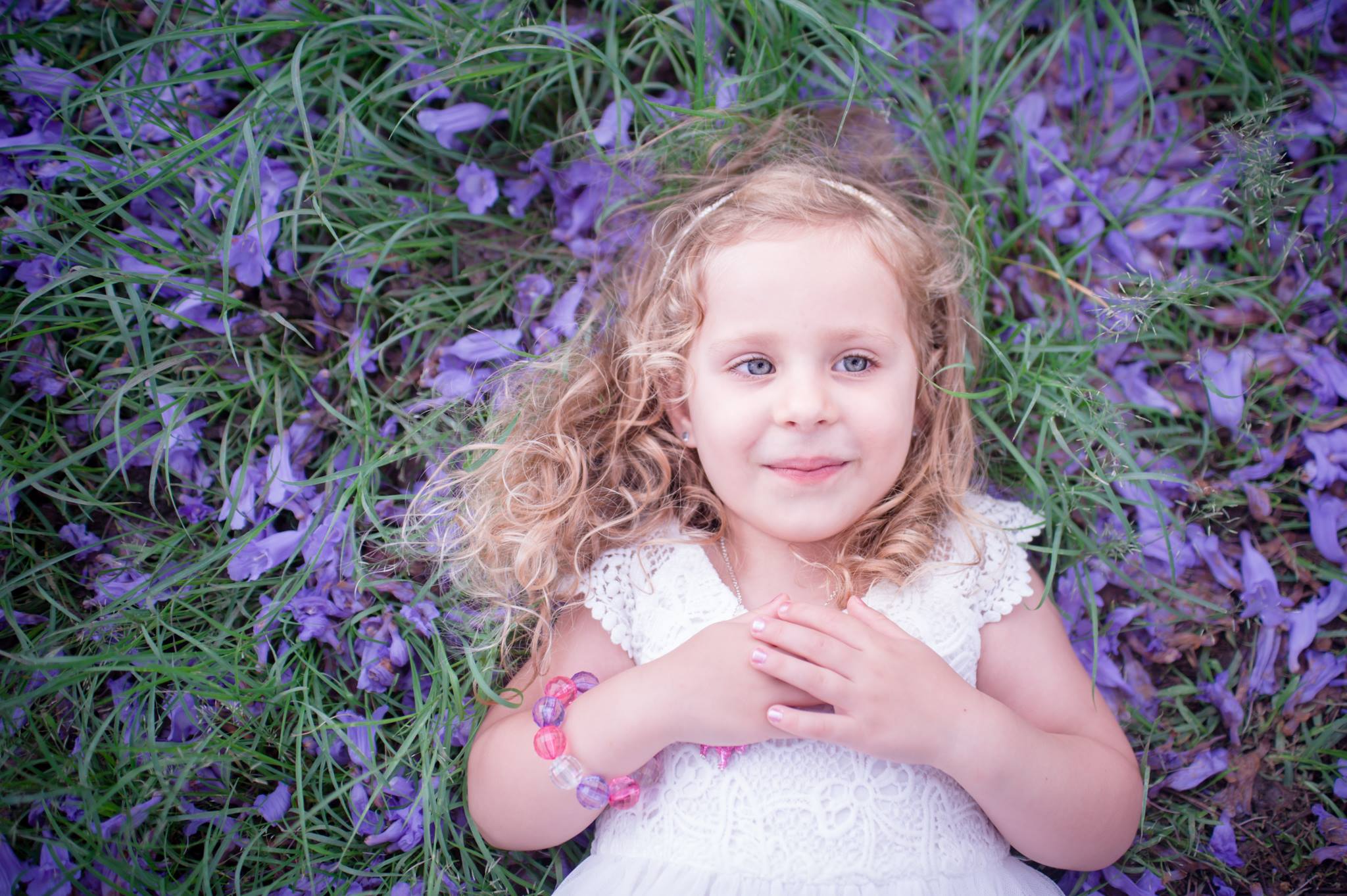  little blond girl with blue flowers behind
