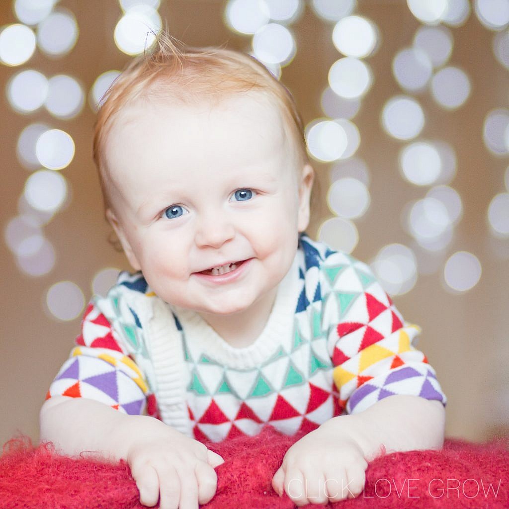 cute baby boy with blue eyes with fairy lights photo background