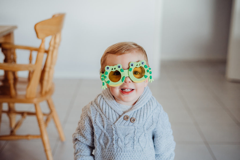 toddler with silly green glasses