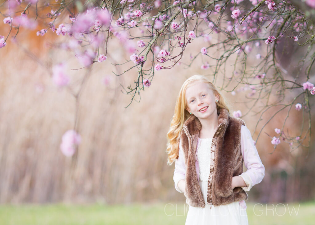 portrait of young girl in cherry blossom field