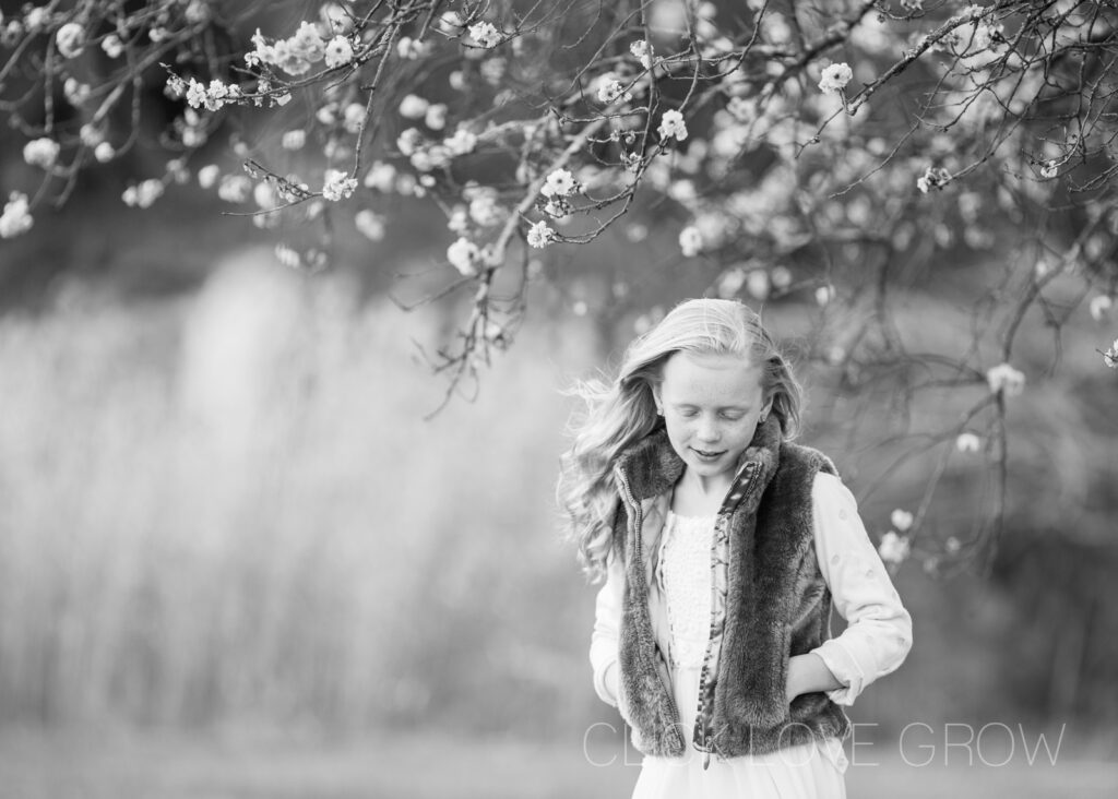 B&W portrait in cherry blossom field