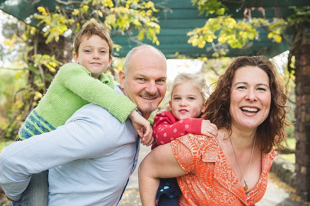 lifestyle family portrait poses with adults holding kids on their back