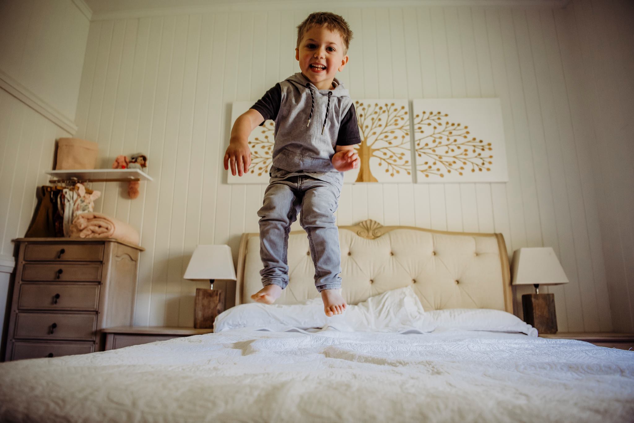 kid jumping on bed