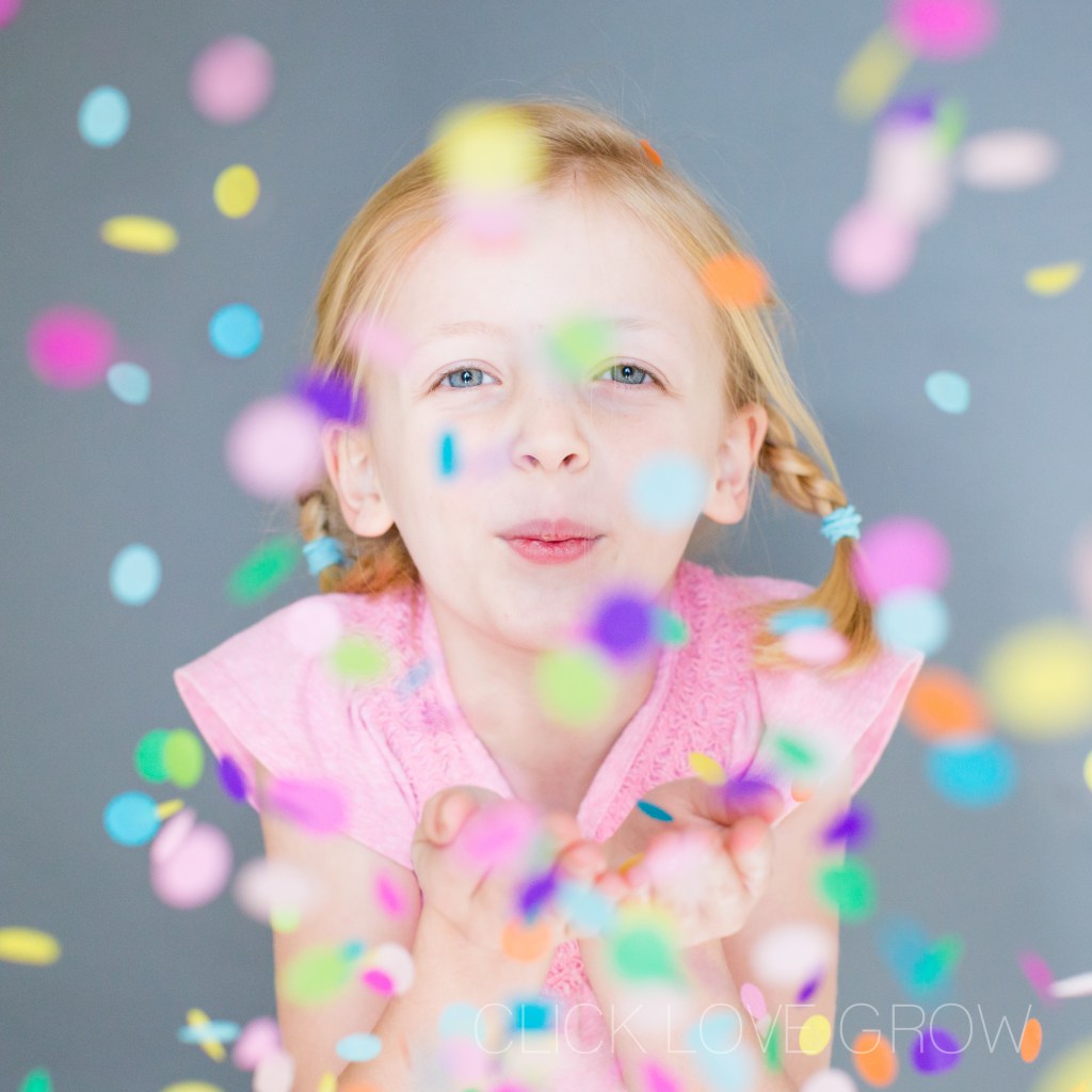 girl blowing confetti during shoot