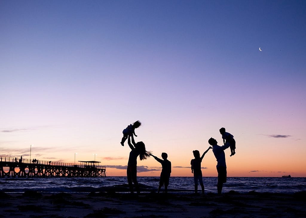 family silhouettes on the beach