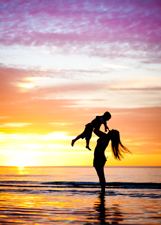sunset silhouette photos of woman and child on the beach