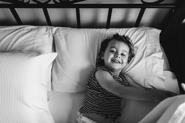 smiling toddler in bed