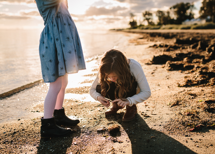 little girl holding sand in her hand