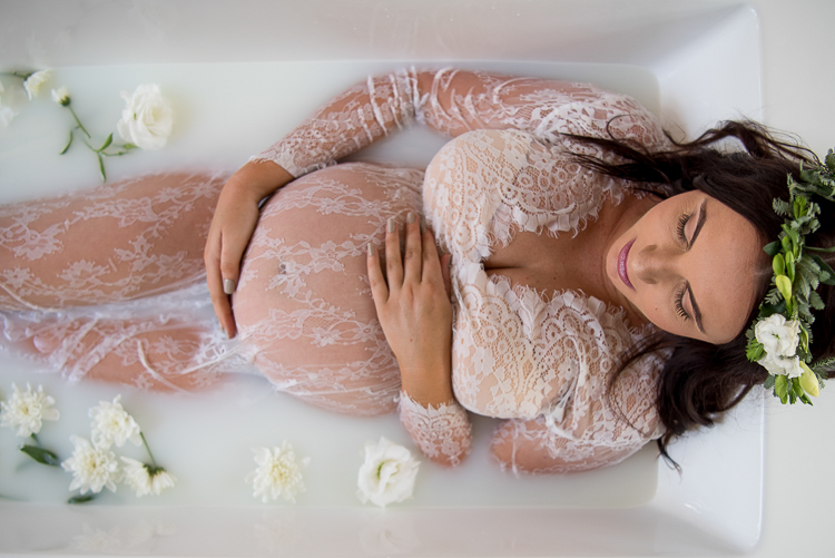 woman during a maternity milk bath photo shoot