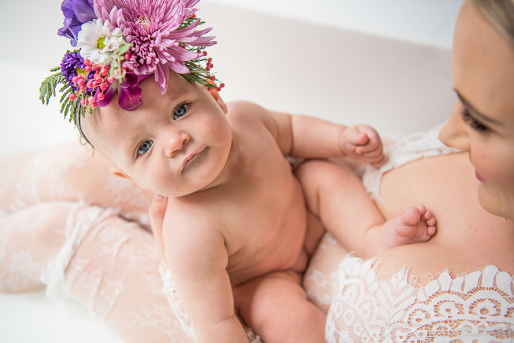 baby looking up during milk bath maternity shoot