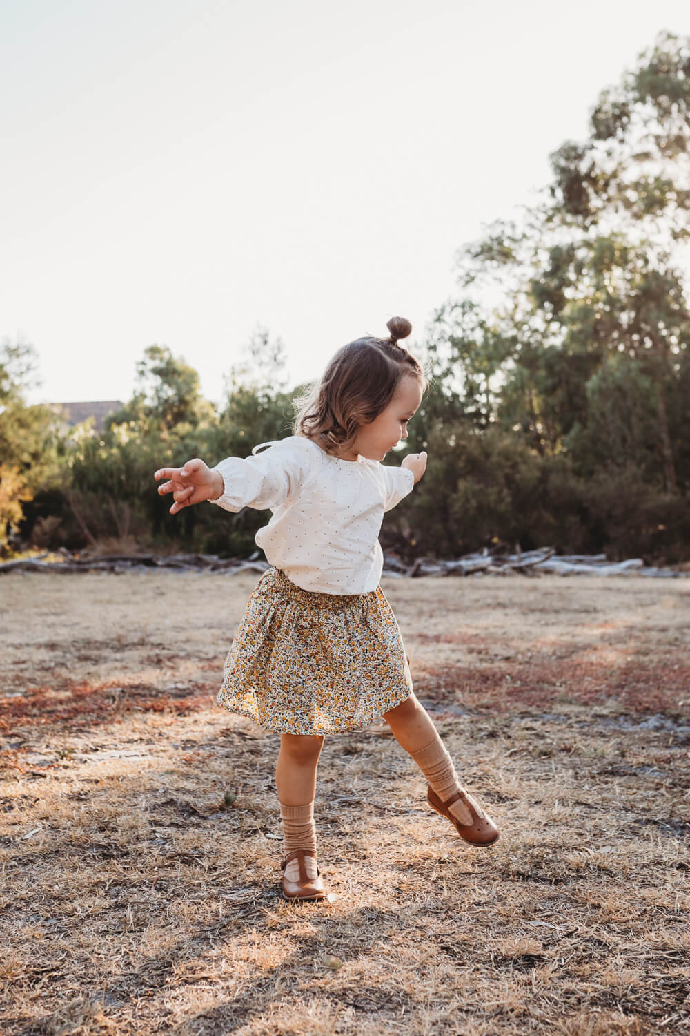 little girl dancing outside