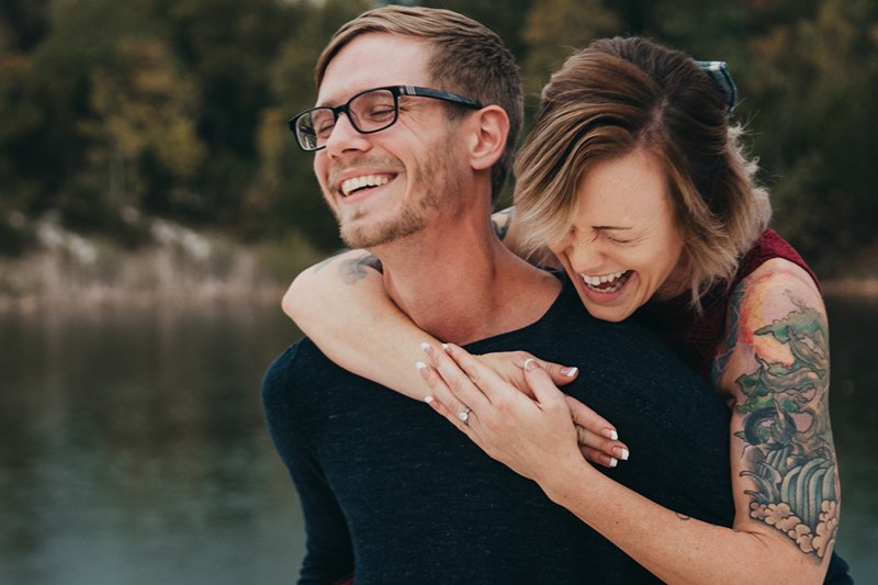 woman hugging man from the back laughing