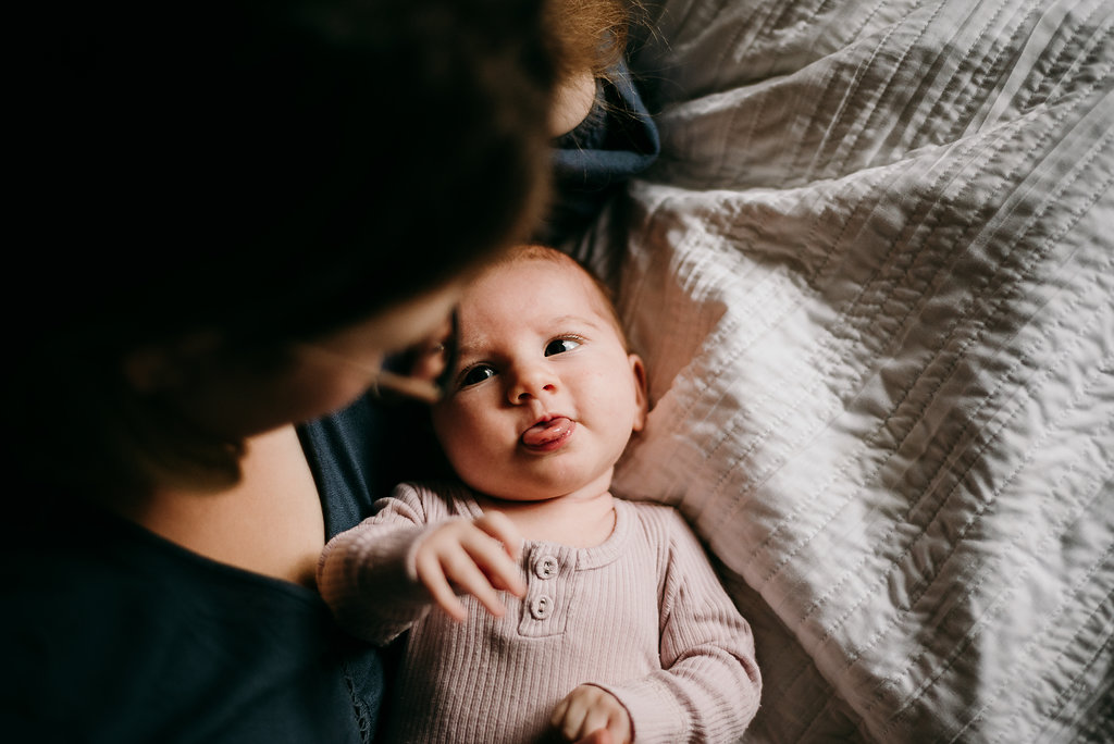 baby looking at mother for lifestyle newborn photoshoot