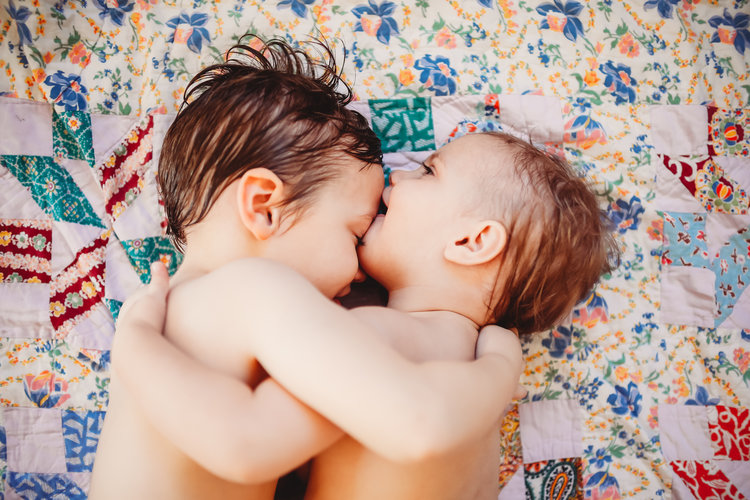 cute photography of little boy hugging and kissing brother’s forehead
