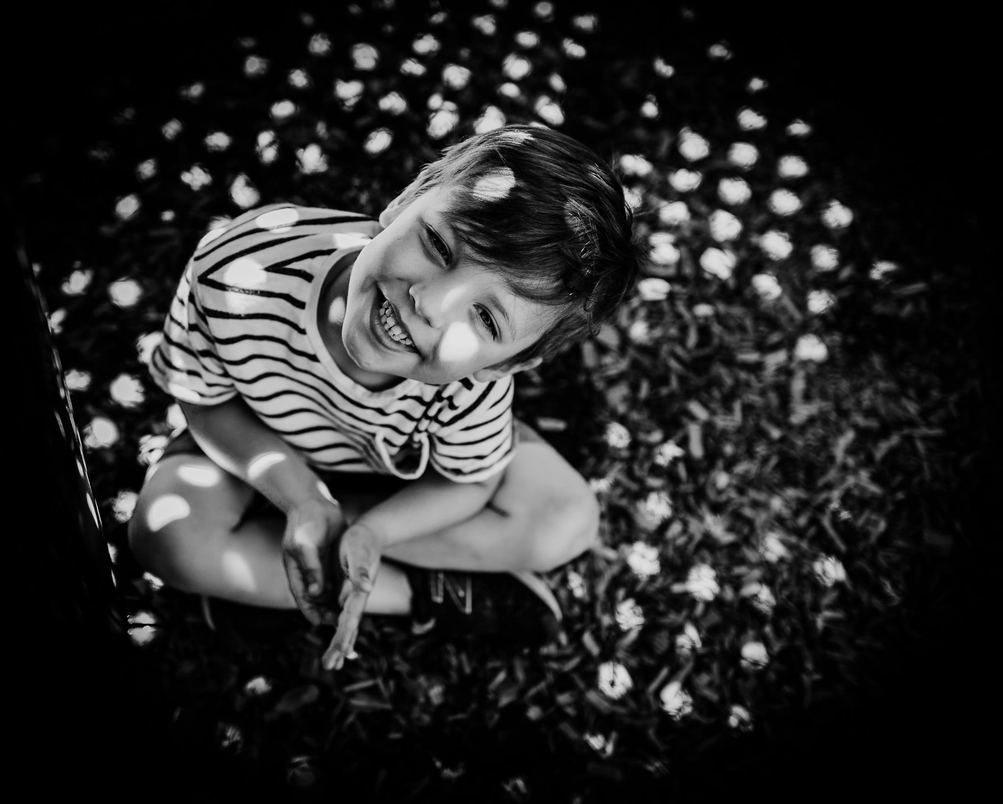 black and white shadow photography of boy smiling
