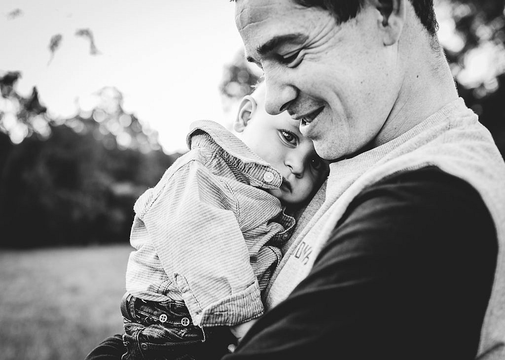 smiling man holding baby 