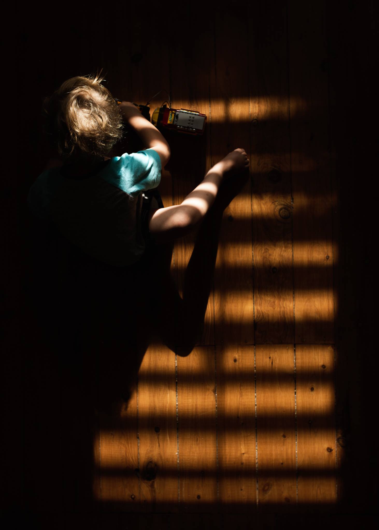 kid playing amongst dark shadows
