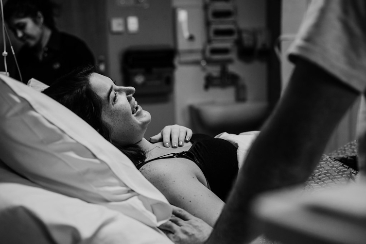 woman on hospital bed laughing