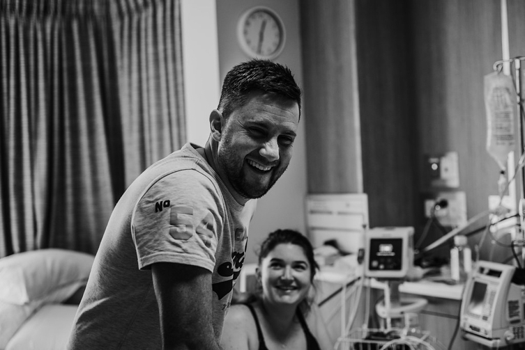 couple laughing in hospital room