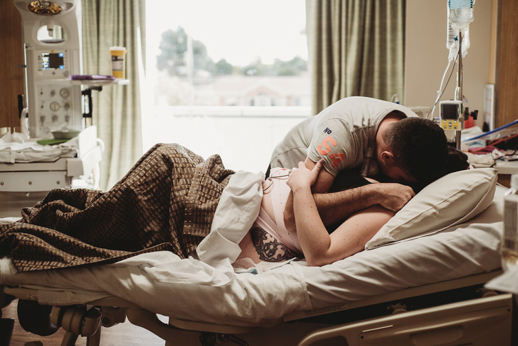 couple hugging each other on hospital bed