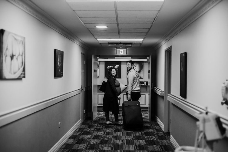 photos of parents-to-be going to their hospital room before c-section