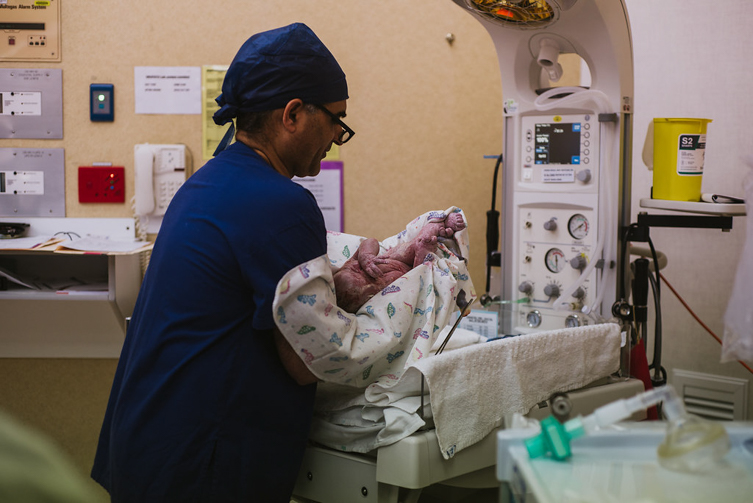 newborn baby getting cleaned