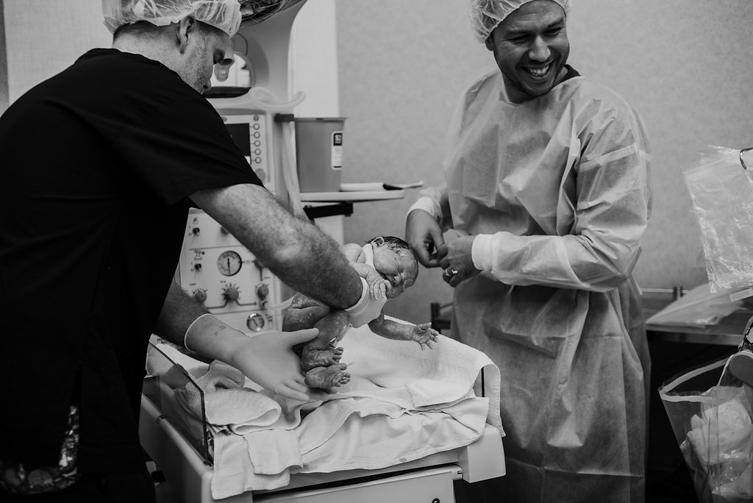 newborn baby getting cleaned