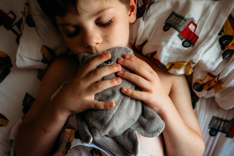 little boy hugging a toy