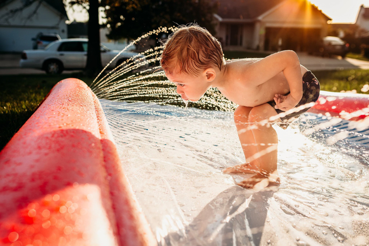shot of boy playing with water