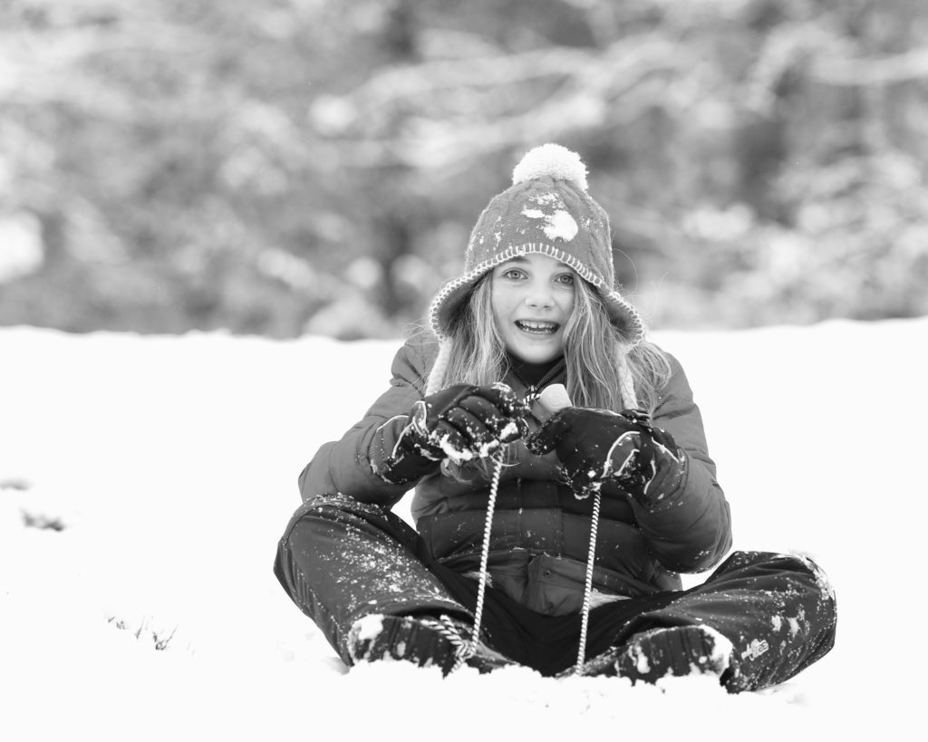 girl sitting in the snow