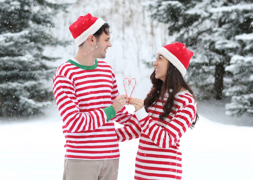 snow day pictures of couple wearing christmas pajamas