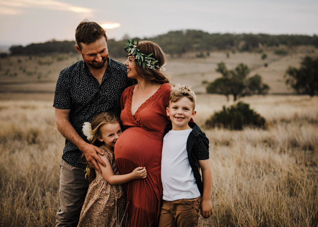whole family standing pose in the field