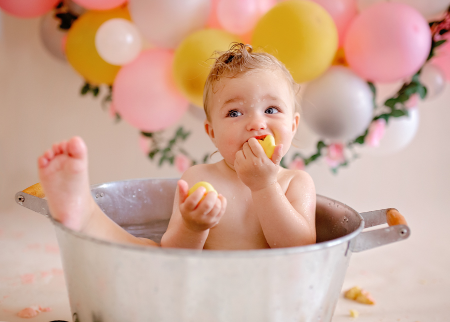 baby in metal bucket during cake smash photoshoot