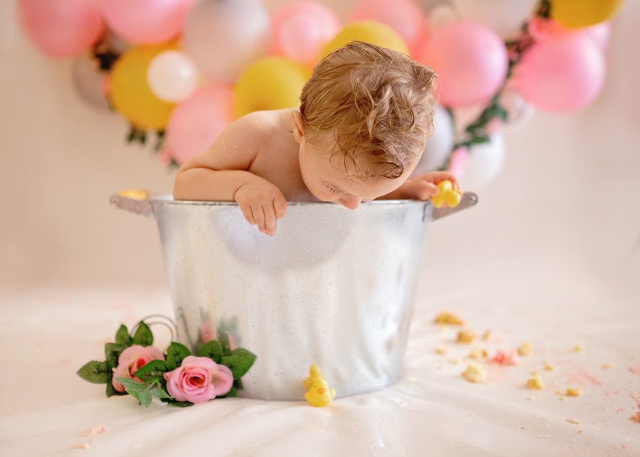 baby in a bucket during cake smash photoshoot