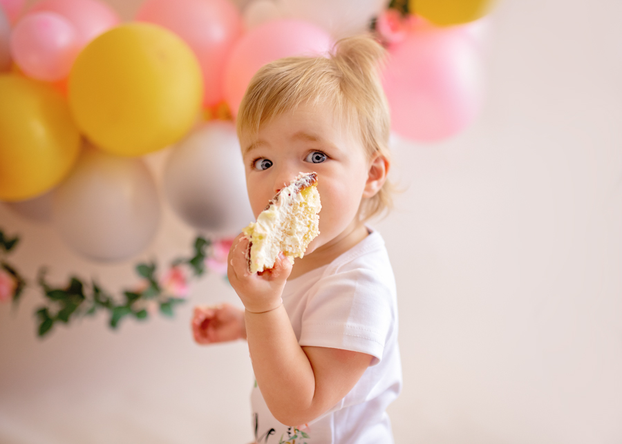 baby eating cake for cake smash photos