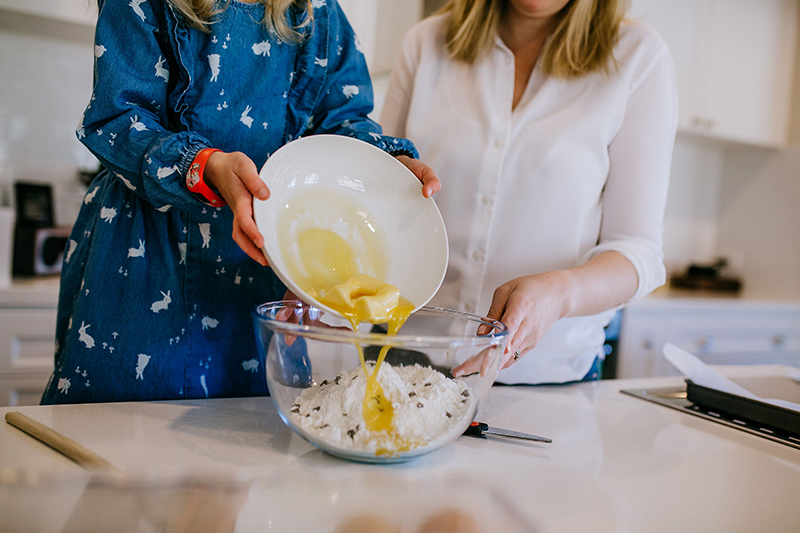 lifestyle image of mother and daughter cooking