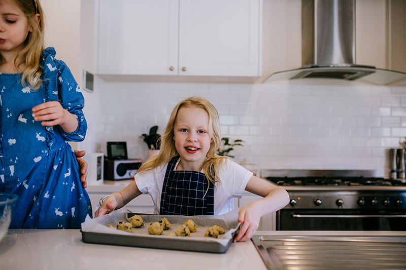 lifestyle photography of little girl cooking