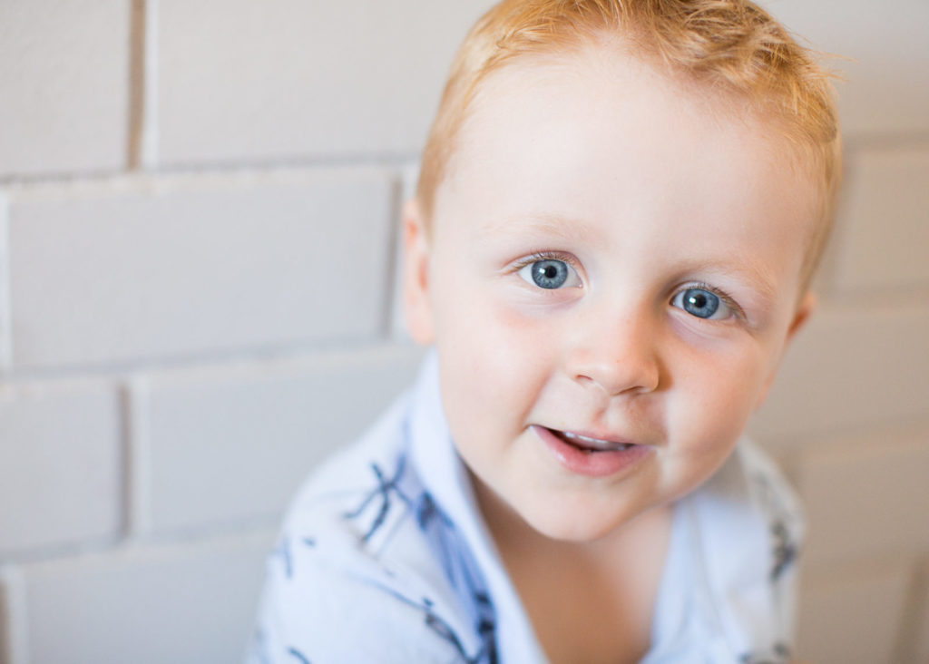  lifestyle vs. portrait photography of little boy looking at the camera