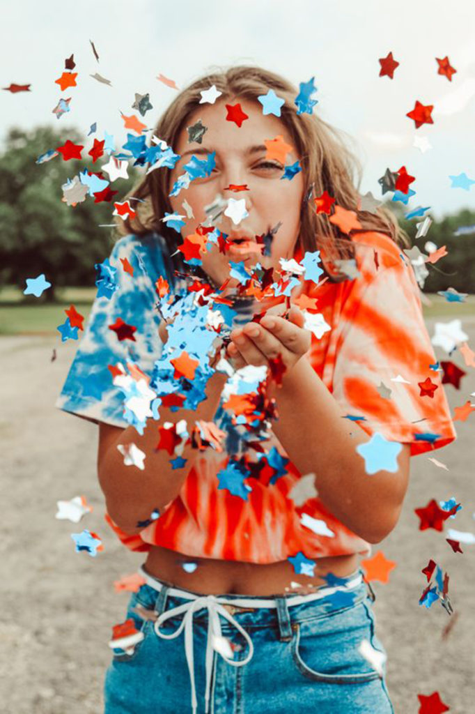 4th of july pics of teenage girl blowing confetti