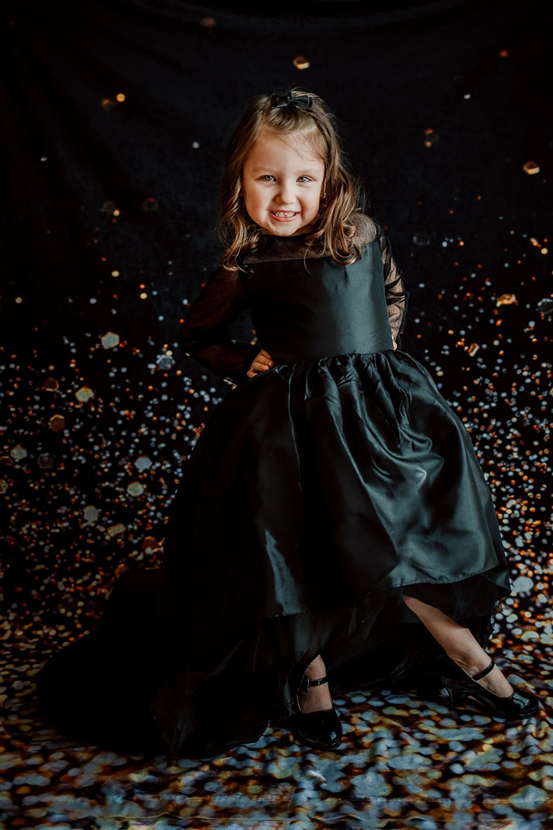 girl in front of confetti backdrop