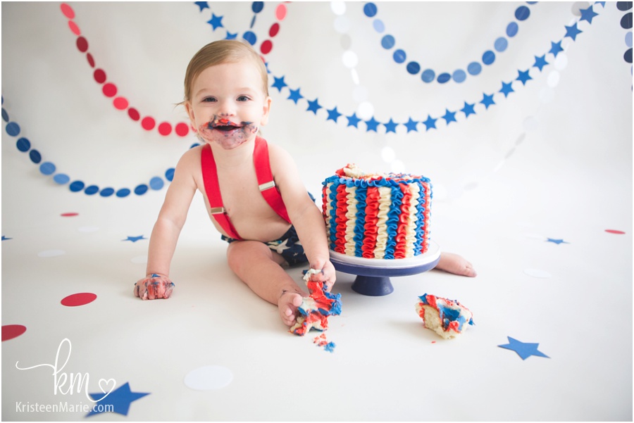 baby eating cake for 4th of july pictures