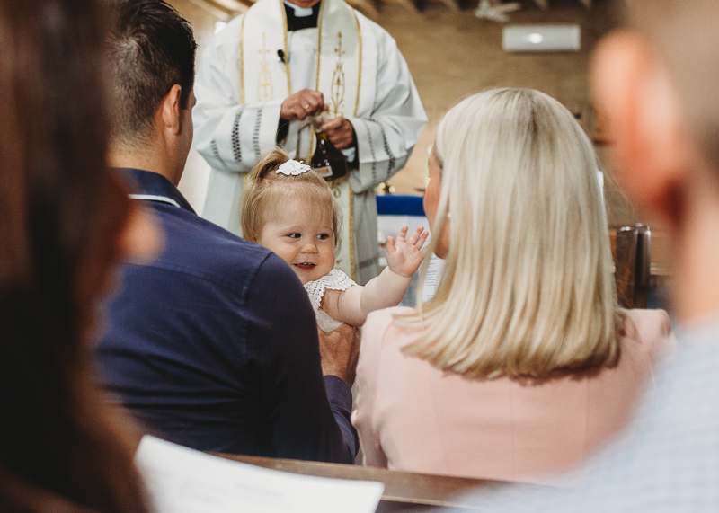 baby laughing in church during baptism
