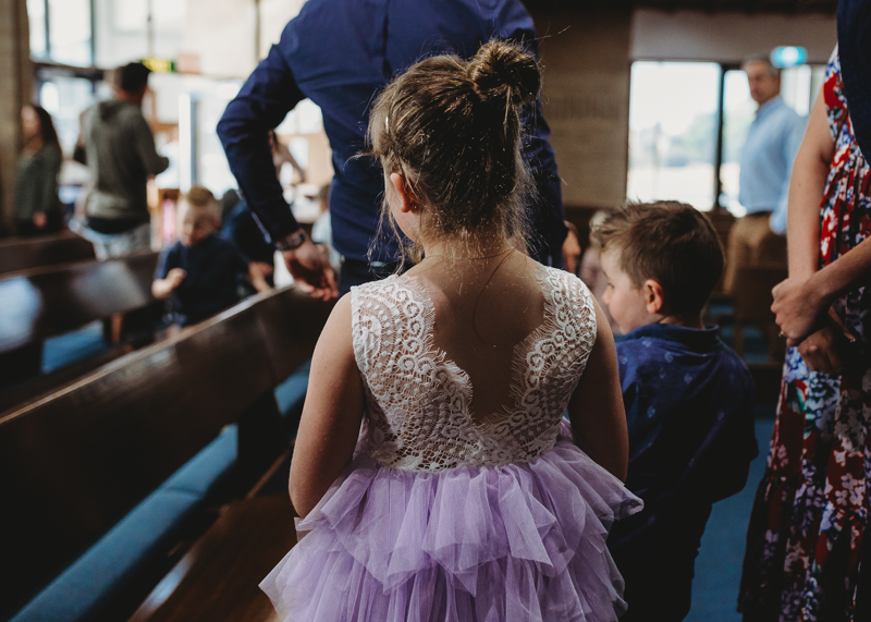 little girl from behind in church during baptism