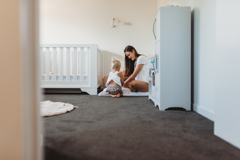  mother and toddler playing in bedroom
