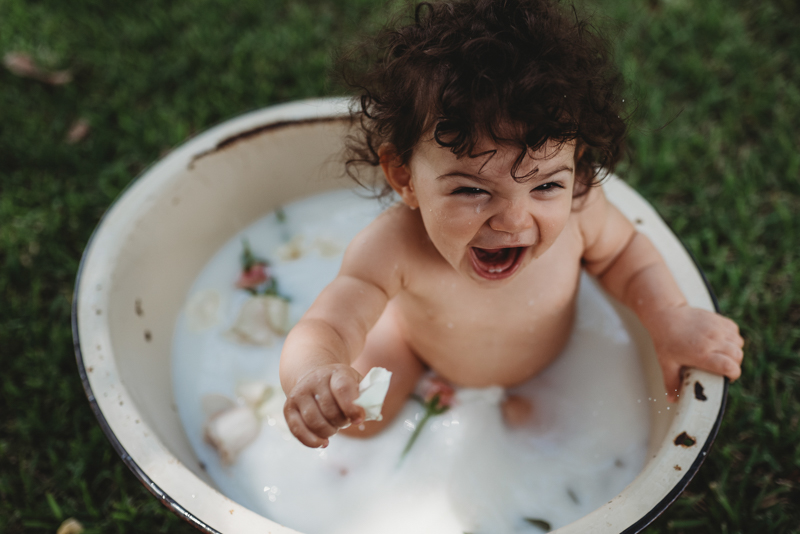 baby girl taking a milk bath