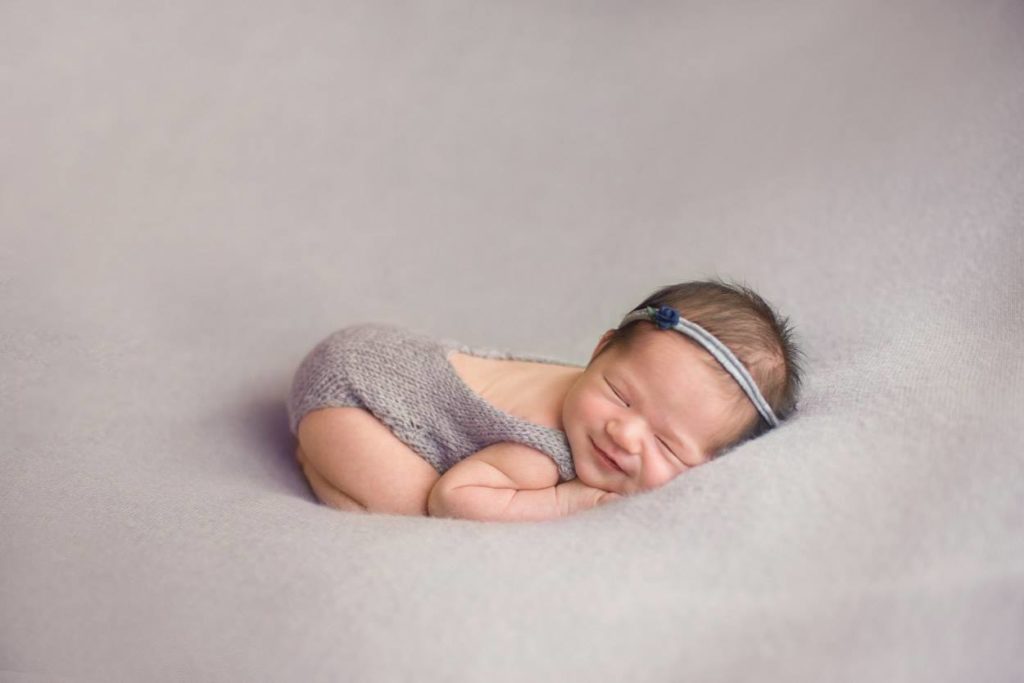 diy newborn photo of baby girl smiling
